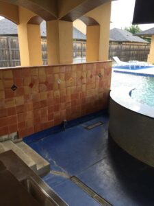 Outdoor pool bar tile installed on walls.