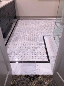 Bathroom remodeled with custom tile floor, paint, new vanity, new counters, shower glass, and shower tile.