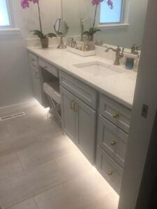 Bathroom remodeled with new wall and floor tile, shower tile, granite counters, vanity, paint, lights, and mirror.