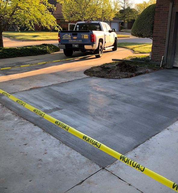 Concrete driveway repair damaged by tree roots.