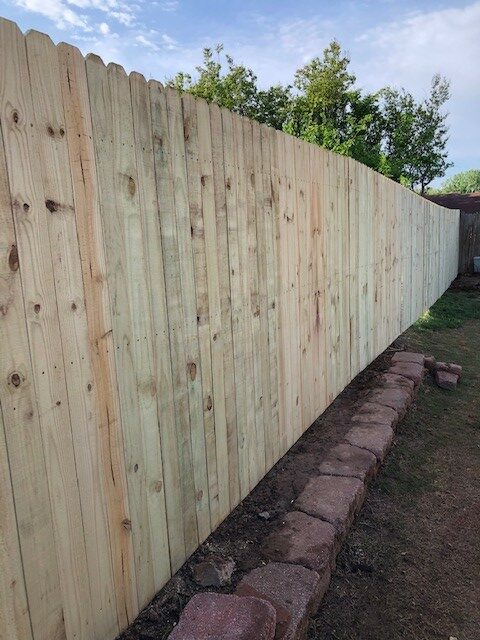 New pine dog-eared 6 foot wood fence.