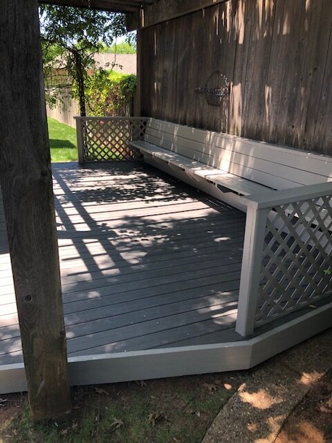 New outdoor synthetic deck and painted wood bench.