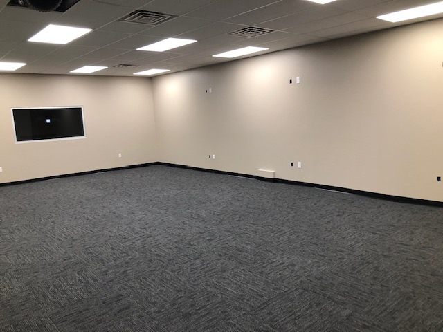 This commercial remodel includes new interior texture and paint, new carpet, new drop-down ceiling, new windows, and door.
