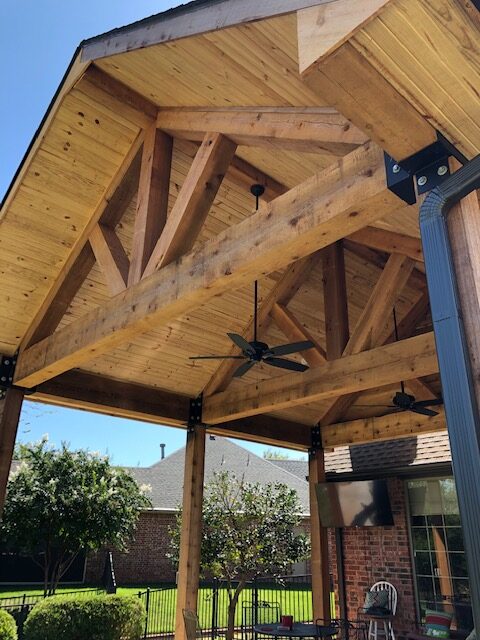 This outdoor cedar patio remodel extended the concrete and added new ceiling fans, outdoor electric and TV hook-up, and gutters.