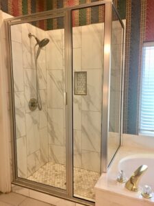 This bathroom was remodeled with new wall and floor tile and new framed shower glass.