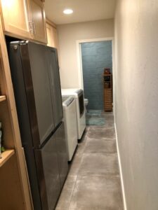 Brand new utility room converted off a portion of the garage with a new attached bathroom. New tile floor, custom cabinets, drywall, and paint.