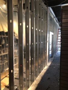 Photo of new metal frame wall within a clothing store.