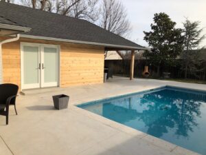 New custom colored concrete. New wood siding. New French door. New outdoor patio.