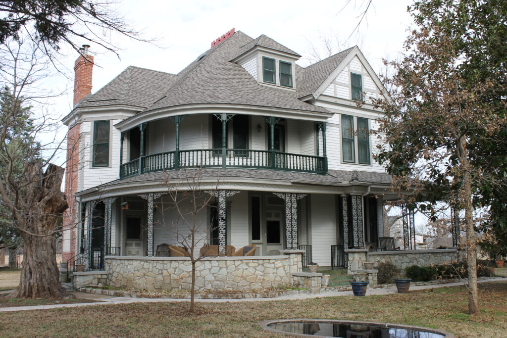 An 1890's bed and bath remodeled with new siding, exterior paint, patio flooring repairs, and new roof.