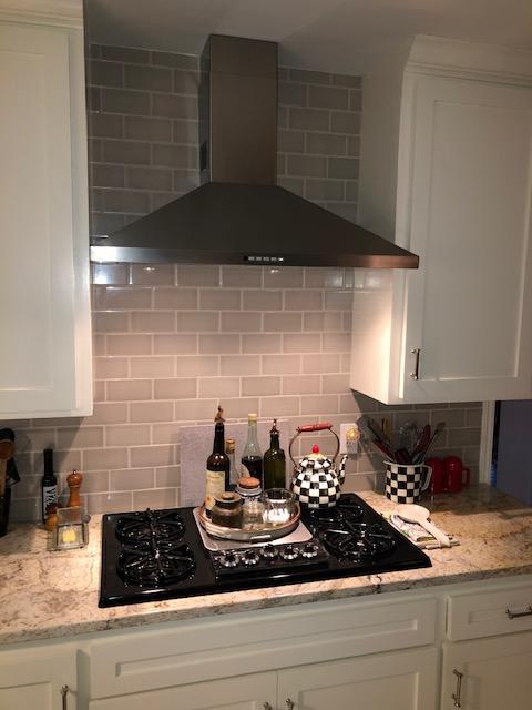 New counters, cabinet paint, backsplash tile, and vent hood.