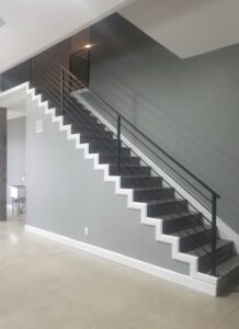 New custom metal stair rail in new construction garage.