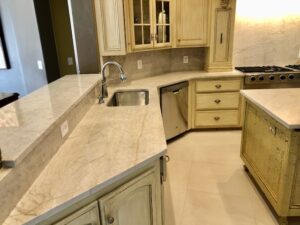 Kitchen with new quartzite countertops and porcelain 24” x 24” floors.