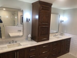New bathroom added to 100-year-old home. Custom cabinetry, mirrors, countertops.