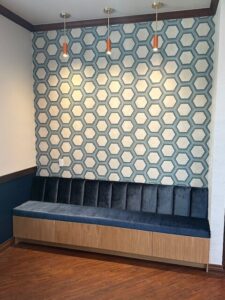 Custom tile wall and velvet covered bench at Orthodontic office.
